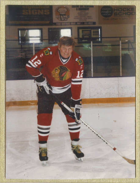 James Smillie on skates in hockey attire